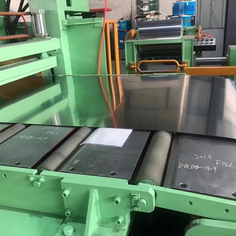 CNC laser cutting machine sizing an ASTM A240 304 stainless steel plate to custom engineering blueprints